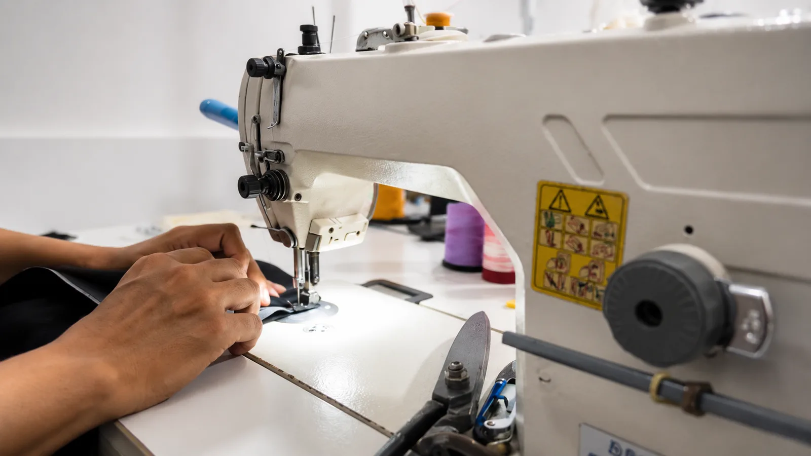 Sewing operator stitching a garment